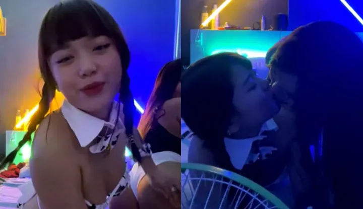 Two girls with double braids take sexy selfies and kiss each other.
